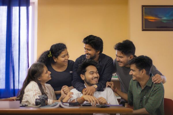 Indian college students collaborating on laptops in a classroom